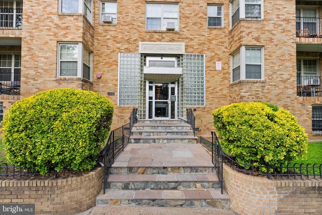 view of exterior entry with brick siding