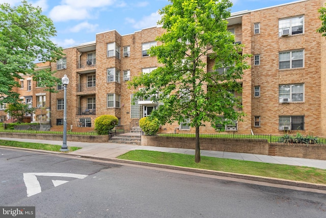 view of apartment building / complex with fence