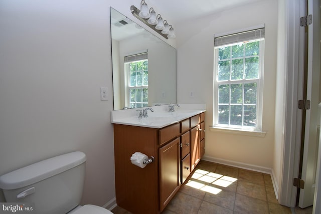 10020 Iron Pointe Dr Unit 9D, Millsboro, DE 19966 - bathroom featuring healthy amount of natural light, toilet, double vanity, and baseboards