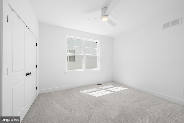 unfurnished bedroom featuring baseboards, carpet, ceiling fan, and a closet