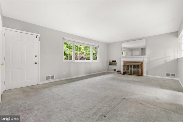unfurnished living room featuring baseboards, a fireplace, and carpet flooring