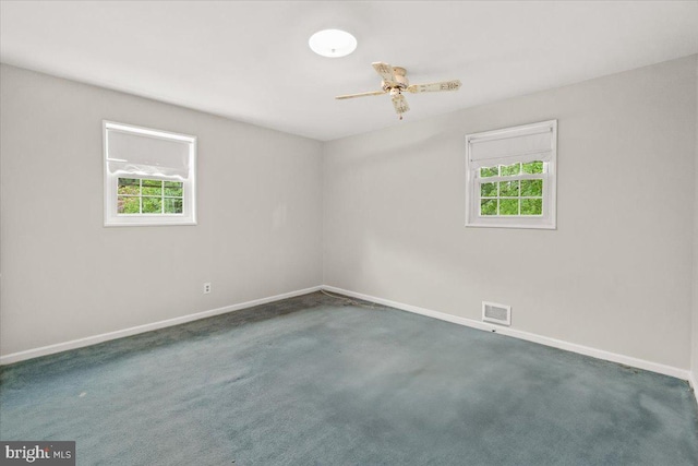 spare room with plenty of natural light, baseboards, carpet flooring, and ceiling fan