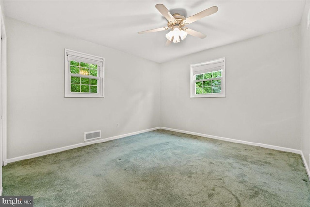 spare room with baseboards, carpet, and ceiling fan