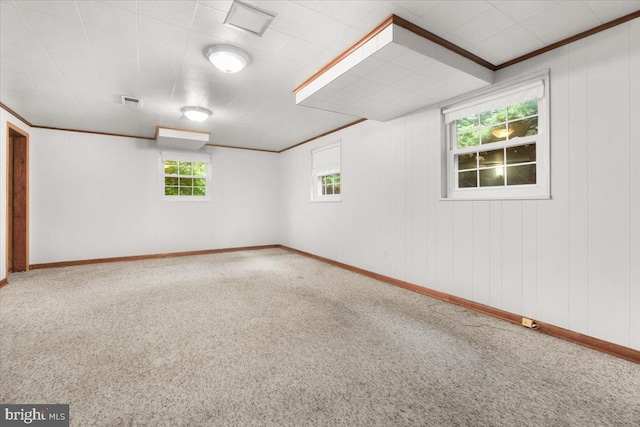 carpeted empty room featuring baseboards and ornamental molding
