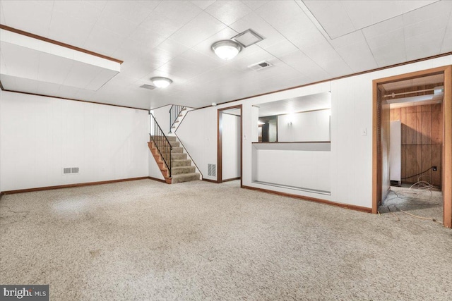 finished below grade area featuring baseboards, stairway, and carpet floors