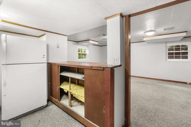 kitchen featuring freestanding refrigerator, baseboards, and carpet floors