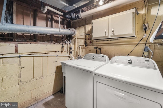 washroom with cabinet space and washer and clothes dryer