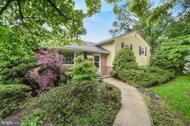 split level home with brick siding