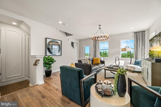 living area featuring wood finished floors, recessed lighting, a chandelier, and baseboards