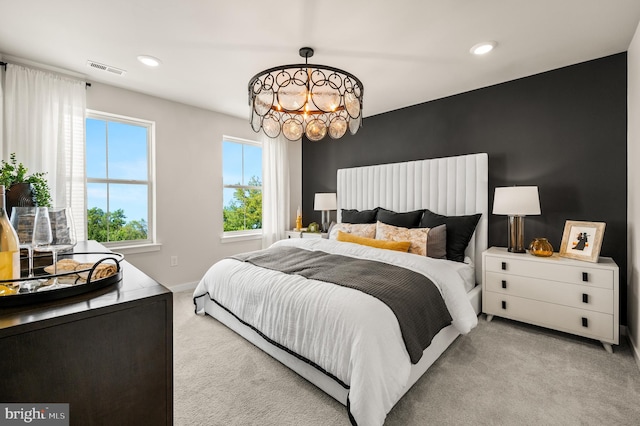 carpeted bedroom with a chandelier, recessed lighting, and baseboards