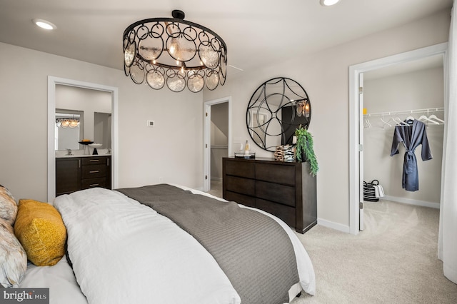 bedroom with a spacious closet, carpet flooring, a chandelier, a closet, and recessed lighting