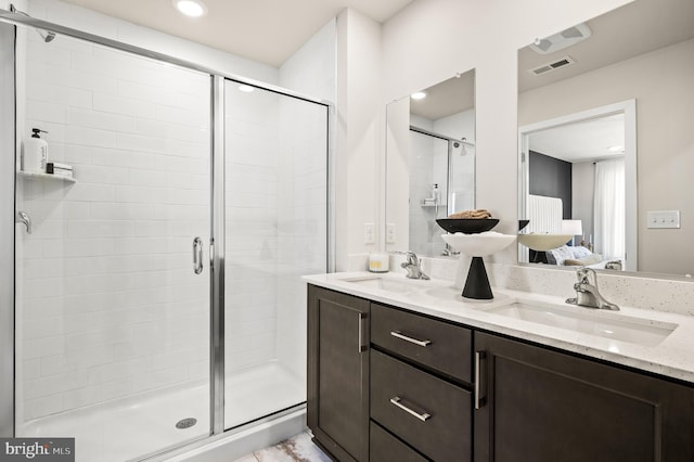 ensuite bathroom with a stall shower and double vanity