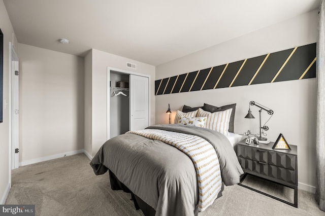 carpeted bedroom featuring a closet and baseboards