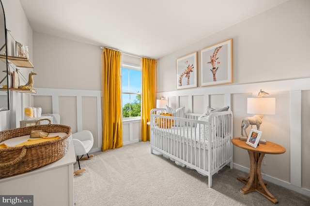 carpeted bedroom with a nursery area