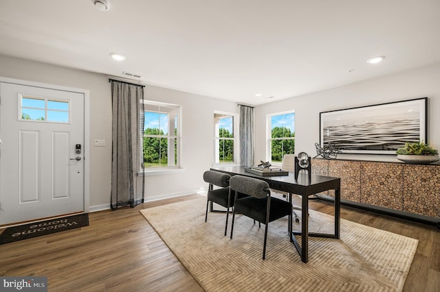 dining room featuring healthy amount of natural light, a desk, wood finished floors, baseboards, and recessed lighting
