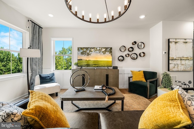 living room featuring wood finished floors, a wainscoted wall, a chandelier, and recessed lighting