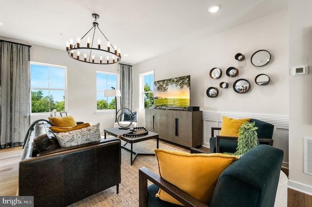 living room with a chandelier, recessed lighting, and a wainscoted wall