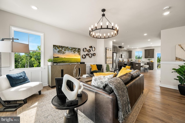 living room featuring wood finished floors, a chandelier, and recessed lighting