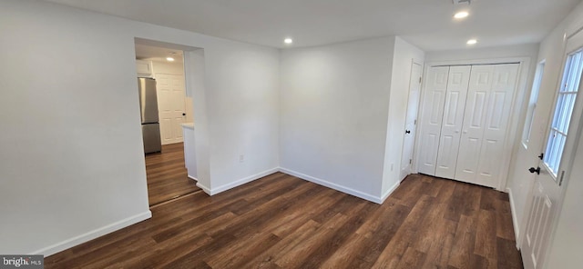unfurnished room with recessed lighting, baseboards, and dark wood-style floors