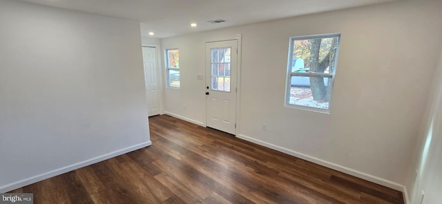 foyer with baseboards, dark wood-type flooring, and recessed lighting