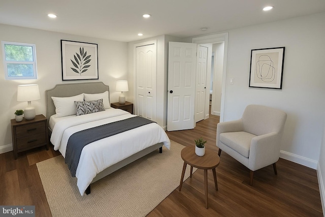 bedroom featuring baseboards, wood finished floors, recessed lighting, and a closet