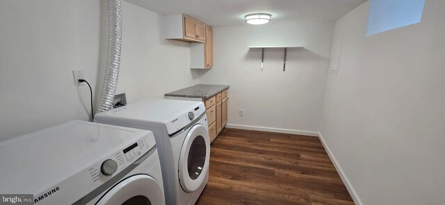 laundry area featuring separate washer and dryer, cabinet space, dark wood-style flooring, and baseboards