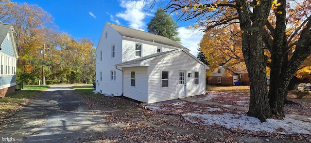 view of side of home featuring driveway