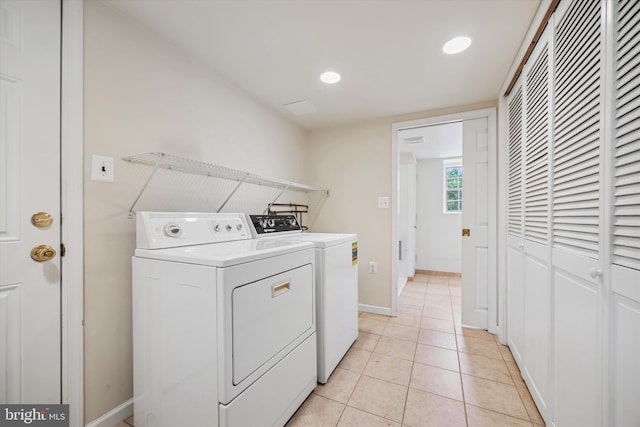 washroom featuring independent washer and dryer, light tile patterned floors, recessed lighting, and baseboards