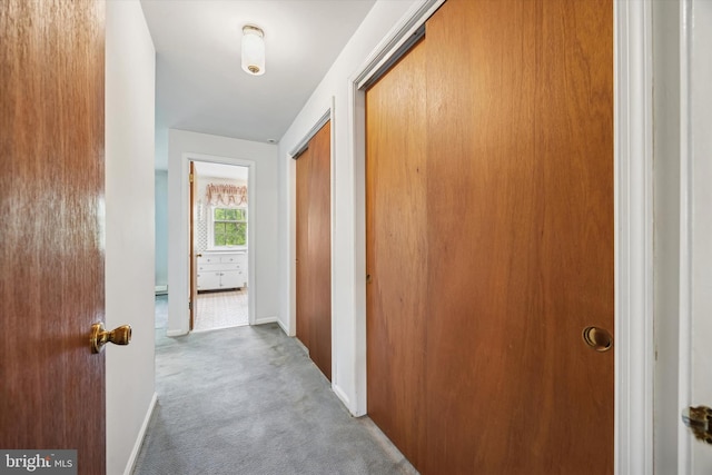 hall with carpet and baseboards