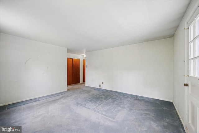 spare room with carpet flooring and baseboards