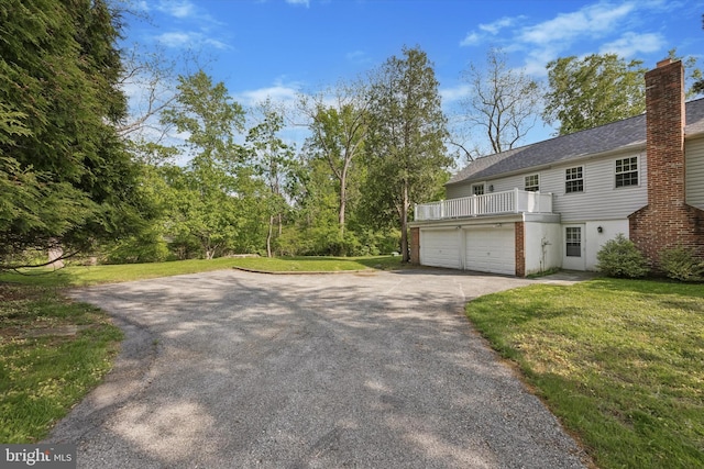 view of property exterior featuring driveway, a yard, and a garage