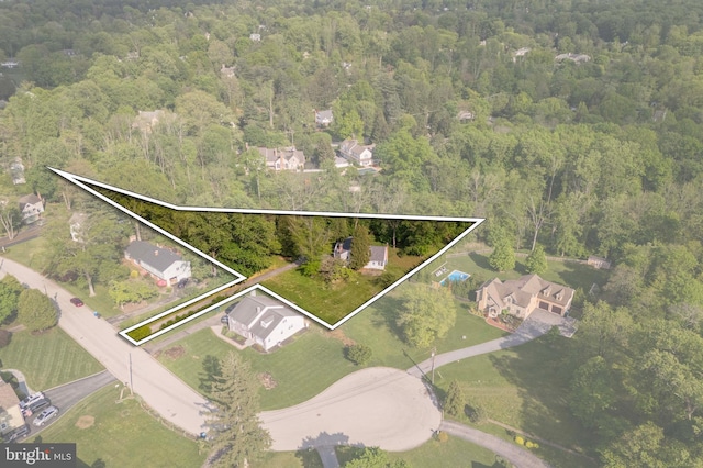 aerial view of property and surrounding area featuring a forest and property boundaries highlighted