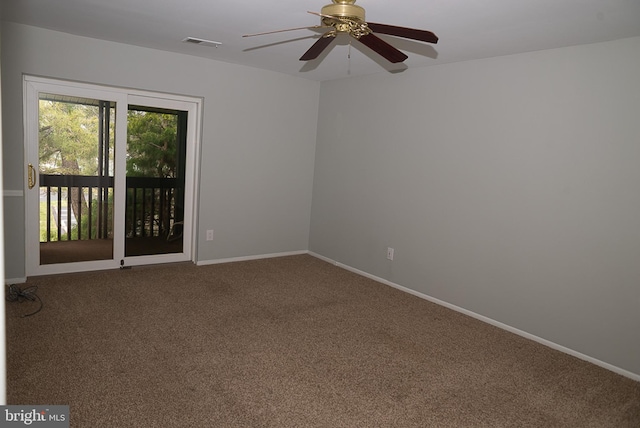 carpeted spare room featuring ceiling fan and baseboards