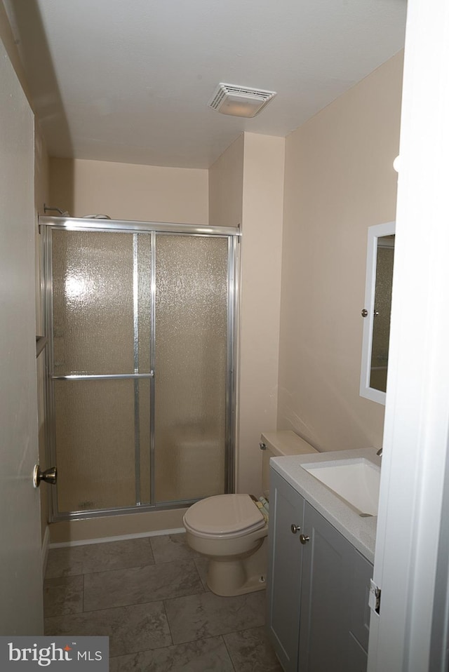 full bath featuring a stall shower, toilet, and vanity
