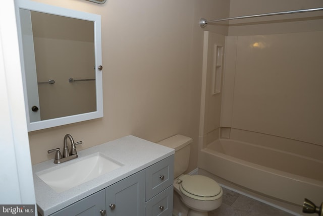 full bath featuring toilet, vanity, tub / shower combination, and tile patterned flooring