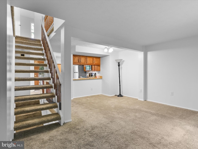 13833 Palmer House Way Unit 32-233, Silver Spring, MD 20904 - unfurnished living room featuring carpet floors, stairway, and baseboards