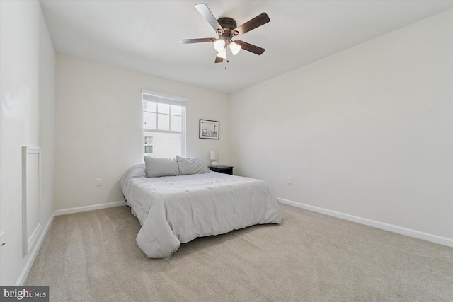 bedroom with carpet, baseboards, and a ceiling fan