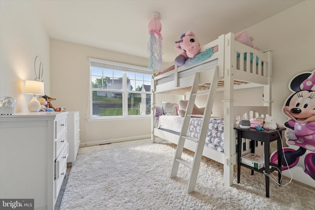 bedroom with carpet and baseboards