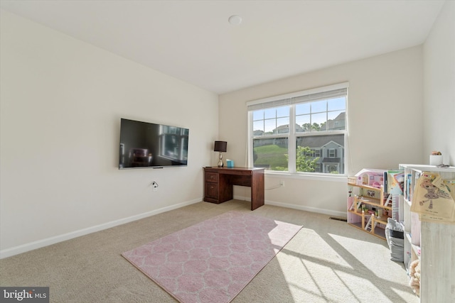 rec room with carpet, baseboards, and an office area