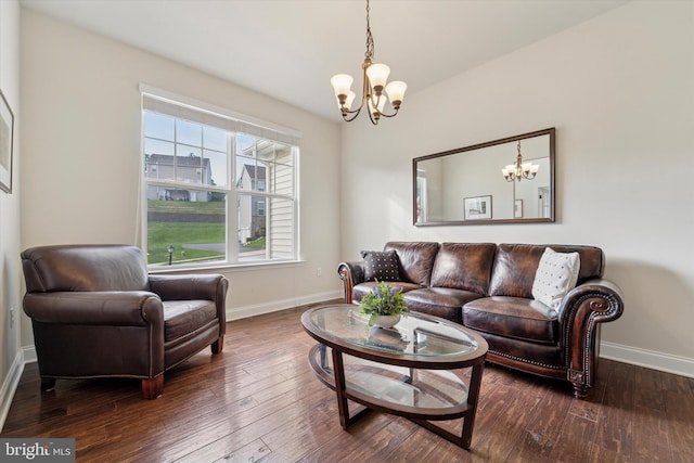 living area with a chandelier, baseboards, and hardwood / wood-style floors