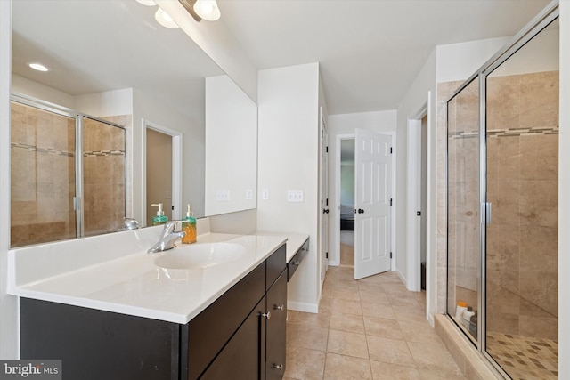 full bath with a stall shower, tile patterned floors, vanity, baseboards, and recessed lighting
