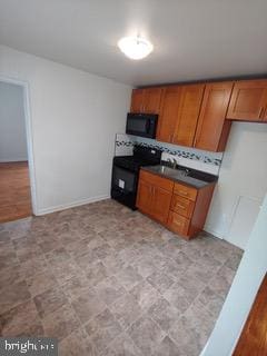 1113 Faunce St, Philadelphia, PA 19111 - kitchen featuring black appliances, brown cabinets, and dark countertops