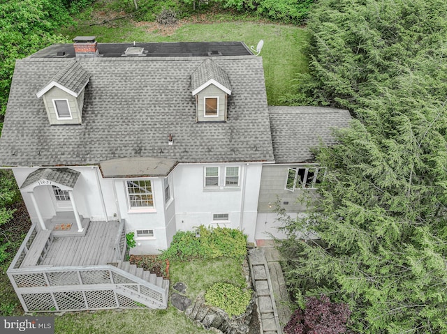 view of front of home featuring roof with shingles, a wooden deck, and stairway