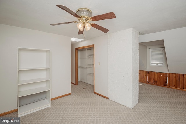 empty room with carpet flooring, ceiling fan, and baseboards