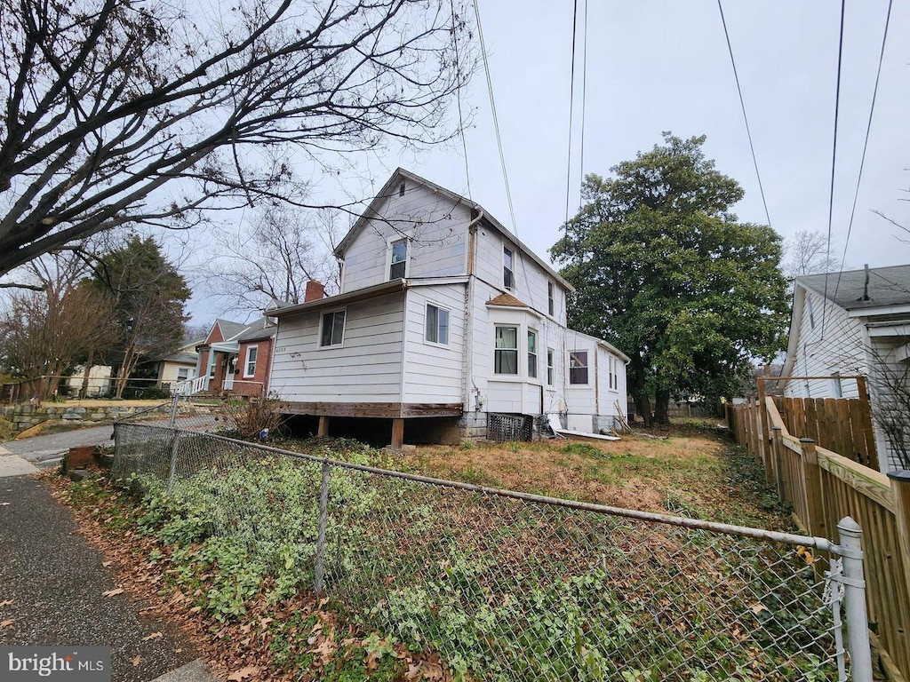 4309 30th St, Mount Rainier, MD 20712 - view of front of property featuring a chimney and a fenced backyard