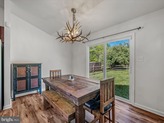326 Soldier Dr, Bunker Hill, WV 25413 - dining room featuring a chandelier, wood finished floors, baseboards, and lofted ceiling