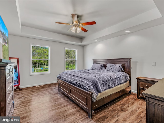 326 Soldier Dr, Bunker Hill, WV 25413 - bedroom with a raised ceiling, wood finished floors, baseboards, recessed lighting, and ceiling fan