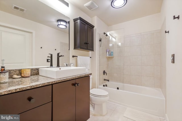 bathroom with toilet, vanity, washtub / shower combination, and tile patterned floors