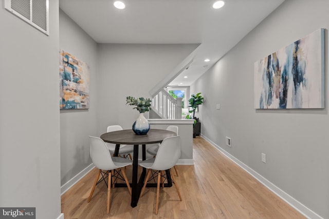 dining space featuring recessed lighting, wood finished floors, and baseboards