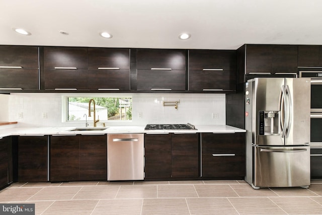 2432 S Culpeper St, Arlington, VA 22206 - kitchen with appliances with stainless steel finishes, a sink, light countertops, decorative backsplash, and recessed lighting